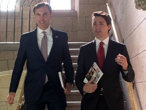 Finance Minister Bill Morneau and Prime Minister Justin Trudeau hold copies of the federal budget on their way to the House of Commons in Ottawa, Wednesday, March 22, 2017. THE CANADIAN PRESS/Adrian Wyld