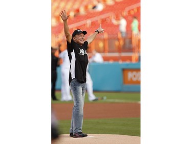 In this July 9, 2011, file photo, actor David Cassidy acknowledges the crowd before throwing out a ceremonial first pitch before a baseball game between the Florida Marlins and the Houston Astros, in Miami. (AP Photo/Wilfredo Lee, File)