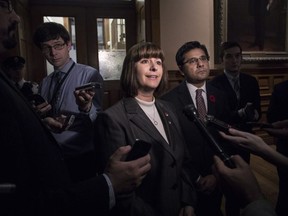 Ontario Minister for Government Services Marie-France Lalonde speaks with journalists outside the Queens Park Legislative chamber in Toronto on Thursday November 1, 2017.