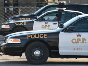 An Ontario Provincial Police officer sits in his cruiser in this Dec. 12, 2012 file photo. (DAN JANISSE/The Windsor Star)