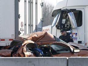 OPP investigate an accident on Highway 401 just east of Prescott Ontario Tuesday Nov 28, 2017. A Quebec trucker was arrested early Tuesday morning hours after two people were killed in a five-vehicle crash late Monday on Highway 401. Tony Caldwell/Postmedia