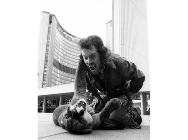 PEAKE ARCHIVES: A man and his pet cougar that he walked on a leash at Toronto City Hall in the 1970s. Laws have changed since then.