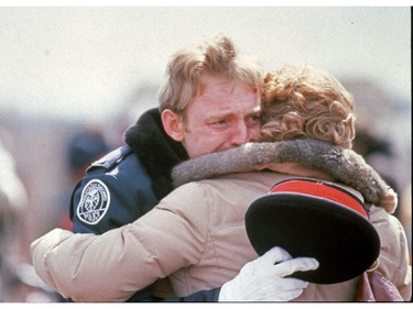 PEAKE ARCHIVES: 1980  An officer hugs someone at the funeral for slain Toronto cop Michael Sweet.