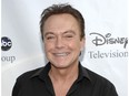 This Aug. 8, 2009 file photo shows actor-singer David Cassidy arrives at the ABC Disney Summer press tour party in Pasadena, Calif.  Cassidy has been hospitalized in Florida. His representative tells The Associated Press on Saturday, Nov. 18, 2017,  that Cassidy is "now conscious" and "surrounded by family." The rep adds that Cassidy was in pain and taken to the hospital on Wednesday. No additional details were provided. (AP Photo/Dan Steinberg, File)