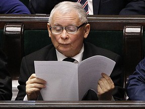 Jaroslaw Kaczynski, leader of the country's ruling Law and Justice party, reads in parliament in Warsaw, Poland, Friday, Nov. 24, 2017.