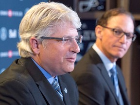 Toronto Argonauts head coach Marc Trestman, right, listens as new general manager Jim Popp speaks during a press conference on Feb. 28, 2017