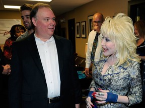 Kirt Webster, Webster Publicity and Singer/Songwriter Dolly Parton. Cracker Barrel Music presents 'An Evening With... Dolly' Gold Record Celebration for her first Gold recording in 11 years and the first Certified Gold Recording in the Cracker Barrel Music Line. Presentation held at Dolly Records/CTK Management on August 10, 2012 in Nashville, Tennessee. (Photo by Rick Diamond/Getty Images)