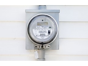 A London Hydro smart meter made by Sensus hangs on the outside wall of a house on Maitland Street in London on Wednesday July 24, 2013.