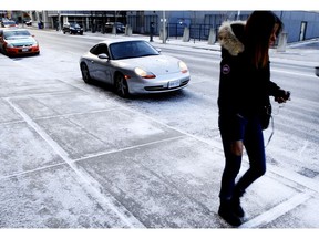 Winter weather hit Toronto on Saturday November 23, 2013. Sidewalks remain slippery as a wet snow freezes on the cement.