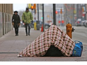 A homeless person is pictured on Bay St. in Toronto.