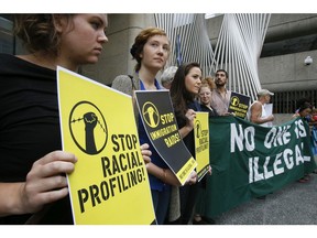 Migrant justice group 'No One Is Ilegal' protested the Ontario Government for racial profiling by the OPP and endless detentions and deportations. They had their rally in downtown Toronto and marched to the Ministry of Transportation offices at Queen's Park,   on Monday August 18, 2014.