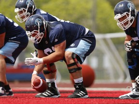Toronto Argonauts centre Sean McEwen snaps the ball  during practice. (Jack Boland/Toronto Sun/Postmedia Network)