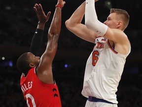 New York Knicks forward Kristaps Porzingis (6) puts up a shot against Toronto Raptors forward CJ Miles (0) during the fourth quarter of an NBA basketball game, Wednesday, Nov. 22, 2017, in New York. The Knicks won 108-100. (AP Photo/Julie Jacobson)