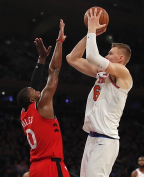 New York Knicks forward Kristaps Porzingis (6) puts up a shot against Toronto Raptors forward CJ Miles (0) during the fourth quarter of an NBA basketball game, Wednesday, Nov. 22, 2017, in New York. The Knicks won 108-100. (AP Photo/Julie Jacobson)