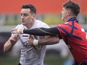 Toronto Wolfpack's Craig Hall (left) breaks past Oxford's Kane Riley to score during their 62-12 win in their inaugural home opener in Kingstone Press League 1 Rugby action in Toronto on Saturday, May 6, 2017.
