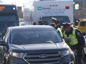 Toronto Police and OPP officers conduct the first spot checks of the annual festive RIDE campaign at Kipling Ave. and Lake Shore Blvd. W. on Wednesday, Nov. 29, 2017.