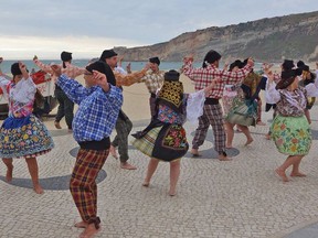 Jovial folk bands and dancers in festive costumes bring life to the sandy sidewalks of Nazare, Portugal. RICK STEVES/SPECIAL TO POSTMEDIA NETWORK