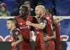 Toronto FC midfielder Michael Bradley (4) celebrates a goal by Victor Vazquez, rear right, during the first half of an MLS Eastern Conference semifinal soccer match against the New York Red Bulls Monday, Oct. 30, 2017, in Harrison, N.J. (AP Photo/Bill Kostroun)