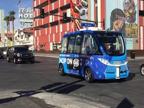 A driverless shuttle bus rolls down a street in Las Vegas, Wednesday, Nov. 8, 2017.