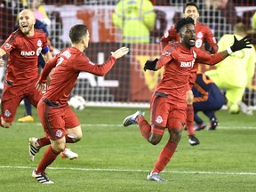 Toronto FC forward Tosaint Ricketts (87), right to left, celebrates his goal with teammates Will Johnson (7) and Michael Bradley (4) during second half MLS soccer playoff action against New York City FC in Toronto, Sunday, October 30, 2016. THE CANADIAN PRESS/Frank Gunn