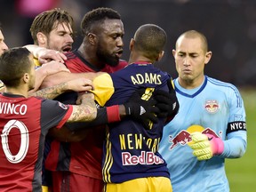 Toronto FC forward Jozy Altidore (17) scuffles with New York Red Bulls midfielder Tyler Adams (4) after teammate Sebastian Giovinco (10) was pushed to the ground during first half MLS soccer action in Toronto on Sunday, November 5, 2017. THE CANADIAN PRESS/Frank Gunn ORG XMIT: FNG506