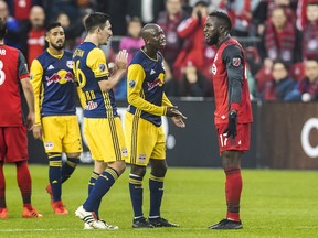 Toronto FC forward Jozy Altidore (17) exchanges words with New York Red Bulls midfielder Sacha Kljestan (16) and his teammate Bradley Wright-Phillips during first half MLS Eastern Conference semifinal action in Toronto on Sunday, November 5, 2017. THE CANADIAN PRESS/Mark Blinch