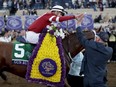 Florent Geroux celebrates after riding Gun Runner to victory in the Classic horse race during the Breeders' Cup, Saturday, Nov. 4, 2017, in Del Mar, Calif. (GREGORY BULL/AP)