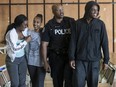 PC Alphonso Carter walks the halls of Cardinal Newman High School greeting and talking with students on Monday June 12, 2017. PC Alphonso Carter is a school resource officer at Cardinal Newman.