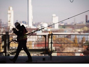 A worker walks on a construction site in Hamilton on November 14, 2013.