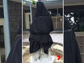 A black tarp now covers a statue of St. Martin de Porres after it was deemed too suggestive by an Australian Catholic school. (Twitter/7NewsAdelaide)
