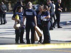 Law enforcement agents investigate a fatal shooting in the Seminole Heights neighborhood in Tampa, Fla., Tuesday, Nov. 14, 2017.