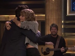 Taylor Swift gives an Jimmy Fallon a hug following her performance on "The Tonight Show." (YouTube screengrab)