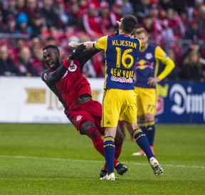 Toronto FC Jozy Altidore and New York Red Bulls’ Sacha Kljestan get into it at BMO Field on Sunday. Ernest Doroszuk/Toronto Sun/Postmedia Network