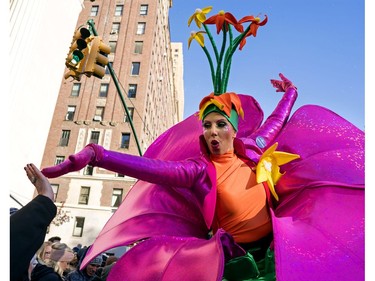 A participant in the Macy's Thanksgiving Day Parade touches hands with a spectator along Central Park West in New York, Thursday, Nov. 23, 2017. (AP Photo/Craig Ruttle)