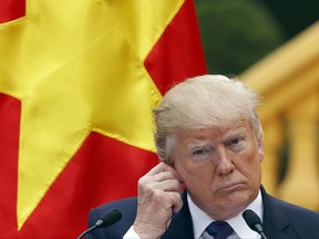 U.S. President Donald Trump attends a press conference at the Presidential Palace in Hanoi, Vietnam Sunday, Nov. 12, 2017. (Kham/Pool Photo via AP)