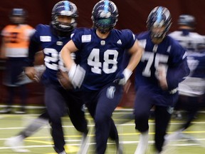 Toronto Argonauts' Akeem Jordan, left to right, Bear Woods and Cameron Walker practise in Ottawa on Nov. 22, 2017