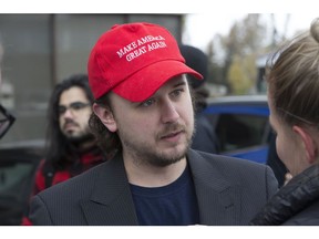 A.J. Ottawa speaks to Sun reporter Brad Hunter as people line up for a discussion being held at the Canadian Christian College. The Toronto Sun was not granted access. Saturday November 11, 2017. Stan Behal/Toronto Sun