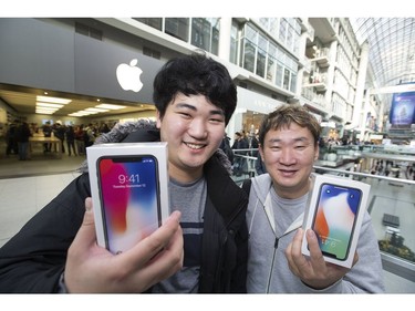 Minsoo Kim and son Mark Kim, app developers are  " insanely excited" as hundreds lined up as early as yesterday afternoon for the opportunity to buy Apple's new iPhoneX at the Eaton Centre,  on Friday November 3, 2017.