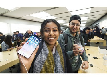 Jessica Kumaran waiting only 2 hours to get into the Apple store as hundreds lined up as early as yesterday afternoon for the opportunity to buy Apple's new iPhoneX at the Eaton Centre,  on Friday November 3, 2017.