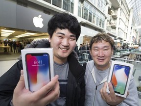 Minsoo Kim and son Mark Kim, App developers are " insanely excited ", as hundreds lined up as early as yesterday afternoon for the opportunity to buy Apple's new iPhoneX at the Eaton Centre, on Friday November 3, 2017.