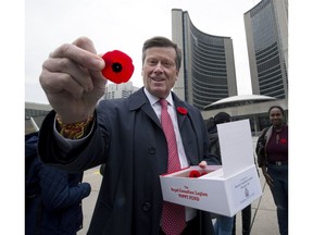 Toronto Mayor John Tory responds to Sun Columnist Joe Warmington’s observation that there are fewer people seen wearing poppies on the streets of Toronto, by handing poppies out in downtown Toronto, Thursday November 9, 2017. Stan Behal/Toronto Sun