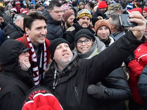 Prime Minister Justin Trudeau poses for a selfie with fans before the 105th Grey Cup on Nov. 26, 2017