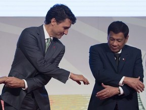 Canadian Prime Minister Justin Trudeau shakes hands with Philippine President Rodrigo Duterte during a photo for the ASEAN-Canada 40th Commemorative session in Manila, Philippines, Tuesday, November 14, 2017.