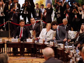 From left to righ: China's President Xi Jinping, Chile's President Michelle Bachelet, Prime Minister Justin Trudeau, Brunei's Sultan Hassanal Bolkiah and Australia's Prime Minister Malcolm Turnbull attend the APEC-ASEAN dialogue on the sidelines of the Asia-Pacific Economic Cooperation (APEC) leaders' summit in the central Vietnamese city of Danang on November 10, 2017.  (JORGE SILVA/AFP/Getty Images)