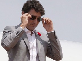Prime Minister Justin Trudeau removes his sunglasses as he arrives in Ho Chi Minh City, Vietnam on Thursday Nov. 9, 2017. Trudeau is sporting P.E.I. made sunglasses from Fellow Earthlings eyewear. THE CANADIAN PRESS/Adrian Wyld