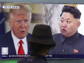 A man watches a TV screen showing U.S. President Donald Trump (left) and North Korean leader Kim Jong Un (right) during a news program at the Seoul Train Station in Seoul, South Korea, on Aug. 10, 2017. (Ahn Young-joon/AP Photo/Files)