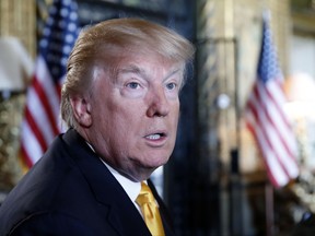 In this Thursday, Nov. 23, 2017 file photo, President Donald Trump speaks to the media before speaking with members of the armed forces via video conference at his private club, Mar-a-Lago, on Thanksgiving in Palm Beach, Fla.