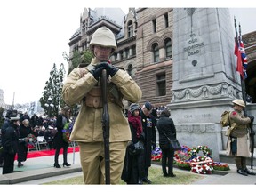 A thousand people braved frigid weather to attend the Remembrance Day Service at the Old City Hall Cenotaph in downtown Toronto on Saturday Nov. 11, 2017.  (STAN BEHAL/Postmedia Network)