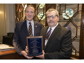 Toronto Press and Media Club president Ed Patrick inducts Mark Bonokoski into the Canadian News Hall of Fame at the Toronto Press and Media Club on Tuesday, November 21, 2017. (Craig Robertson/Toronto Sun)