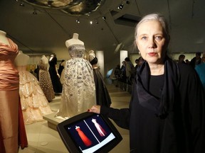 Dr. Alexandra Palmer, senior curator of the ROM's new  Christian Dior exhibit, poses near a display of Dior gowns. The exhibition continues through March 18.